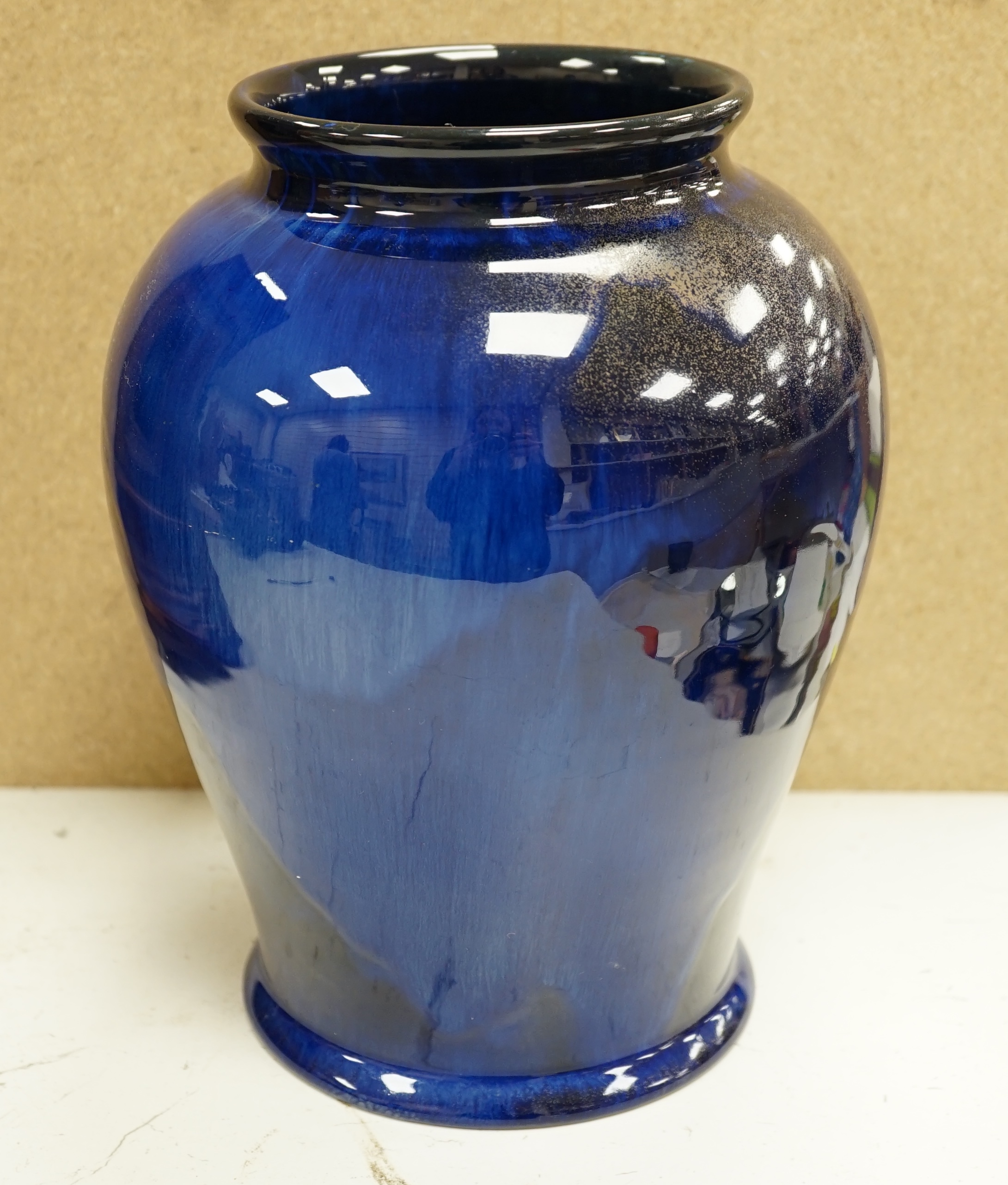 An experimental Doulton Lambeth blue glazed with gilt spray vase, 24cm. Condition - good